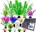 A 16-piece BOYIEENTER aquarium decoration set featuring colorful artificial plastic plants and a smooth fish cave rock.