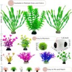 A 16-piece BOYIEENTER aquarium decoration set featuring colorful artificial plastic plants and a smooth fish cave rock.