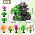 A gray resin castle aquarium decoration with arched entrances, surrounded by eight green and purple artificial aquarium plant