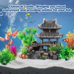 A gray resin castle aquarium decoration with arched entrances, surrounded by eight green and purple artificial aquarium plant