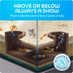 A dark brown, textured FISHNOSH aquarium cave, designed to look like natural driftwood, placed in a fish tank corner.