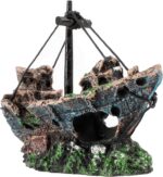 A detailed, multicolor Raeasily shipwreck resin aquarium ornament depicting a sunken vessel amidst aquatic plants, adding cha