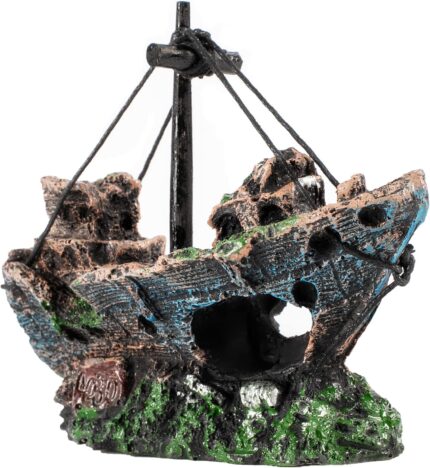 A detailed, multicolor Raeasily shipwreck resin aquarium ornament depicting a sunken vessel amidst aquatic plants, adding cha