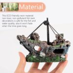 A detailed, multicolor Raeasily shipwreck resin aquarium ornament depicting a sunken vessel amidst aquatic plants, adding cha