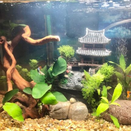 Multicolor resin castle aquarium decoration featuring an Eastern Tower design, providing shelter for fish.