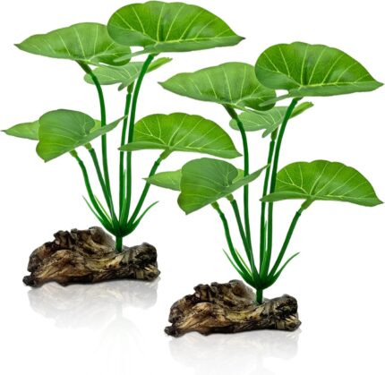 Two UreverFins artificial silk aquarium plants with driftwood bases, realistic green and brown colors, in a fish tank.