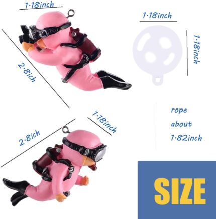 Two pink floating diver ornaments with tiny oxygen tanks and cameras, submerged in a clear fish tank with bubbles.