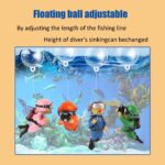 Two pink floating diver ornaments with tiny oxygen tanks and cameras, submerged in a clear fish tank with bubbles.