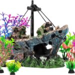 An 8-piece aquarium decoration set featuring a multicolored resin sunken ship and seven artificial green aquatic plants.