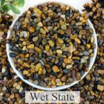 A clear bag filled with 5 pounds of multicolor, rounded 1/4-inch natural river rocks, suitable for aquariums and plants.